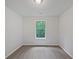 Empty bedroom with neutral carpet, white walls, and large window at 7155 Homestead Rd, Rex, GA 30273
