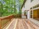 Wooden deck with wood railing and a backyard view of mature trees and the side of the house at 7155 Homestead Rd, Rex, GA 30273