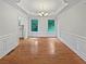 Formal dining room featuring hardwood floors, decorative molding, tray ceiling, and a modern chandelier at 7155 Homestead Rd, Rex, GA 30273