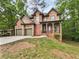 Beautiful two-story brick home with a spacious driveway and a two car garage surrounded by mature trees at 7155 Homestead Rd, Rex, GA 30273