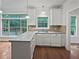 Bright kitchen with white cabinets, granite countertops, and a view of the backyard and wooden deck at 7155 Homestead Rd, Rex, GA 30273