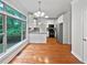 Eat-in kitchen featuring white cabinets, stainless steel appliances, and hardwood floors at 7155 Homestead Rd, Rex, GA 30273