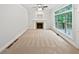 Bright living room featuring fireplace and large window, ready for your personal touch at 7155 Homestead Rd, Rex, GA 30273