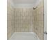 Bathroom shower with new fixtures, shower head and white tiled walls and tub at 7155 Homestead Rd, Rex, GA 30273