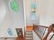 Bright foyer with staircase, wood floors and lots of natural light from the beautiful architectural windows at 7155 Homestead Rd, Rex, GA 30273