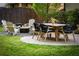 Landscaped backyard with table, six chairs, fire pit and Adirondack chairs at 917 Gaylemont Cir, Decatur, GA 30033