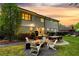 Landscaped backyard with outdoor seating, fire pit, and a view of the home's exterior at sunset at 917 Gaylemont Cir, Decatur, GA 30033
