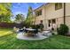 Beautiful backyard with a stone patio, dining area, outdoor grill, and steps leading to the house at 917 Gaylemont Cir, Decatur, GA 30033