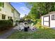 Inviting backyard featuring a patio with a fire pit, seating area, and a storage shed surrounded by mature trees at 917 Gaylemont Cir, Decatur, GA 30033