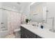 Charming bathroom featuring a gray vanity, a shower-tub combination, and playful decor at 917 Gaylemont Cir, Decatur, GA 30033
