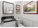 Elegant powder room with dark granite countertop, white wainscoting, and tasteful decor at 917 Gaylemont Cir, Decatur, GA 30033
