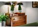 Bedroom featuring wooden dresser, two lamps, and decorative plants at 917 Gaylemont Cir, Decatur, GA 30033