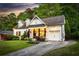 Charming white brick home featuring dormer windows and a well-manicured front yard at dusk at 917 Gaylemont Cir, Decatur, GA 30033