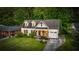 Aerial view of a charming white brick home featuring dormer windows and a well-manicured front yard at 917 Gaylemont Cir, Decatur, GA 30033