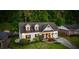 Aerial view of a charming white brick home featuring dormer windows and a well-manicured front yard at 917 Gaylemont Cir, Decatur, GA 30033