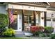 Charming front porch with rocking chairs, an American flag, and decorative hanging planters at 917 Gaylemont Cir, Decatur, GA 30033