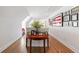 Stylish hallway featuring hardwood floors, gallery wall, half-moon table with decor, and natural light at 917 Gaylemont Cir, Decatur, GA 30033