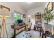Comfortable home office featuring wood paneling, a large window, and built-in bookshelves at 917 Gaylemont Cir, Decatur, GA 30033