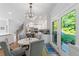 Open-concept kitchen featuring white cabinets, an island, stainless steel appliances, and backyard views at 917 Gaylemont Cir, Decatur, GA 30033