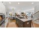 Open kitchen with island seating and views of the living room and staircase at 917 Gaylemont Cir, Decatur, GA 30033