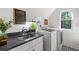 Bright laundry room featuring a sink, modern washer and dryer, and patterned floors at 917 Gaylemont Cir, Decatur, GA 30033