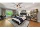 Comfortable main bedroom featuring hardwood floors, ceiling fan, area rug, and reading nook at 917 Gaylemont Cir, Decatur, GA 30033