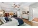 Comfortable main bedroom with an ensuite featuring hardwood floors, ceiling fan, and an exercise bike at 917 Gaylemont Cir, Decatur, GA 30033