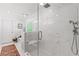 Bathroom featuring a frameless shower with marble surround, a seat, and dual shower heads at 917 Gaylemont Cir, Decatur, GA 30033