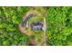 Aerial view of brick home with mature landscaping and circular drive surrounded by tall trees at 2498 Highway 212, Covington, GA 30016