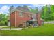 Brick home's backyard featuring a covered patio and spacious lawn at 2498 Highway 212, Covington, GA 30016
