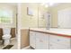 Well lit bathroom featuring single sink vanity with white cabinets and tile flooring at 2498 Highway 212, Covington, GA 30016