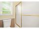 Bathroom featuring bathtub and shower with a frosted glass enclosure and a window at 2498 Highway 212, Covington, GA 30016