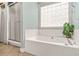 Bright bathroom with a soaking tub under a window, and a separate shower at 2498 Highway 212, Covington, GA 30016