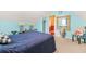 Bedroom with blue walls and carpet featuring a large bed, small table, and decorations at 2498 Highway 212, Covington, GA 30016