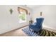 Bright bedroom with a cozy blue armchair, carpet, and natural light at 2498 Highway 212, Covington, GA 30016