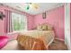 Pink bedroom with a bed, window, patterned wallpaper trim, and a pink beanbag at 2498 Highway 212, Covington, GA 30016