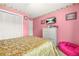 Bedroom with pink walls and a bed, including a TV, chest of drawers, and carpet at 2498 Highway 212, Covington, GA 30016