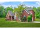 Side view of a beautiful two-story brick house featuring a well-maintained lawn and landscaping at 2498 Highway 212, Covington, GA 30016