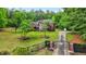 Inviting two-story brick home features a manicured lawn, mature trees, and gated entrance at 2498 Highway 212, Covington, GA 30016