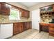 Kitchen featuring wooden cabinets, tile backsplash, and white appliances at 2498 Highway 212, Covington, GA 30016