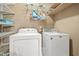 Laundry room features a washer, dryer, and ample shelving at 2498 Highway 212, Covington, GA 30016