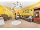 Cozy living room with plush sofas, ceiling fan, and stairs in background at 2498 Highway 212, Covington, GA 30016