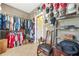 Spacious walk-in closet with custom shelving, lots of clothing, and wall decor at 2498 Highway 212, Covington, GA 30016