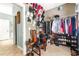 Large walk-in closet featuring custom shelving and organization system at 2498 Highway 212, Covington, GA 30016