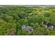 An aerial view shows the layout of a neighborhood with homes amidst lush greenery at 424 Melrose Ave, Decatur, GA 30030