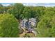 Aerial view of a blue two-story home surrounded by lush trees in a neighborhood setting at 424 Melrose Ave, Decatur, GA 30030