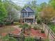 Charming backyard with a covered patio, lush garden, stone pathways and a fenced yard at 424 Melrose Ave, Decatur, GA 30030