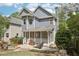 Well-manicured backyard featuring a patio, screened porch, fire pit, and lush greenery at 424 Melrose Ave, Decatur, GA 30030