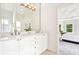Bathroom with double vanity, an arched ceiling and view into bedroom at 424 Melrose Ave, Decatur, GA 30030