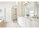 Elegant bathroom featuring a glass shower, double vanity, and a soaking tub at 424 Melrose Ave, Decatur, GA 30030